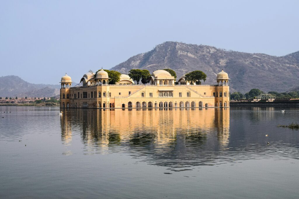 Jal Mahal, the water palace in Jaipur, reflecting in Man Sagar Lake with serene mountain backdrop.