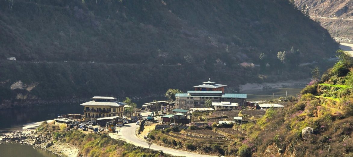 A beautiful aerial view of Punakha Dzong with a river and mountains in the background, capturing the essence of Bhutan.